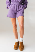 A woman wearing the Vitality Uni Cozy Short in Violet
