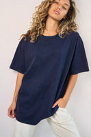A woman wearing the Vitality Retro Uni Tee - Oxford Washed