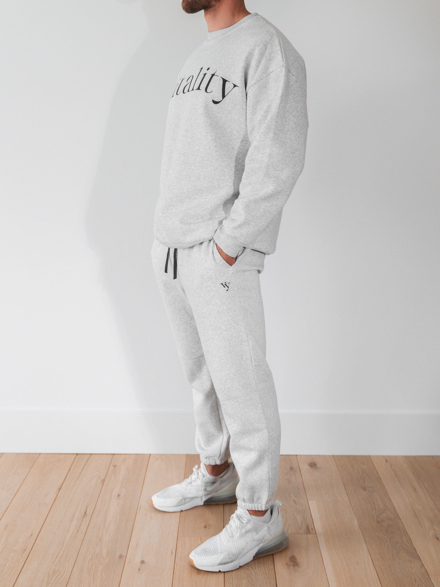 A man wearing the Vitality Cozy Uni Jogger in Stone Marl