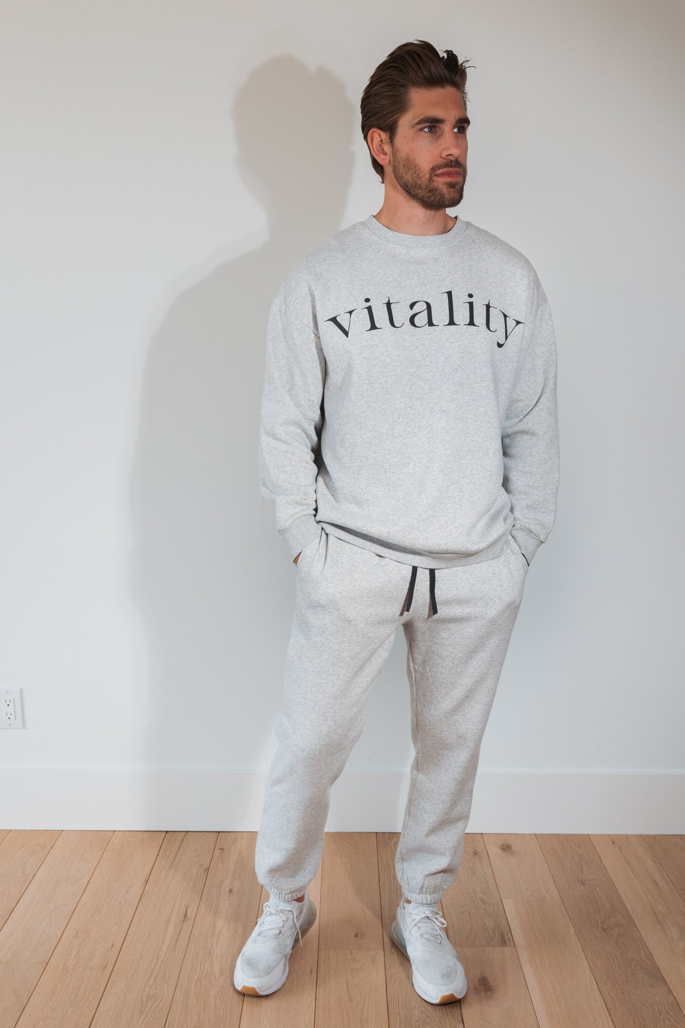 A man wearing the Vitality Cozy Uni Crew in Stone Marl