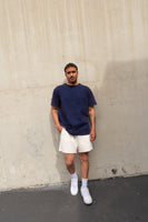 A man wearing the Vitality Retro Uni Tee - Oxford Washed