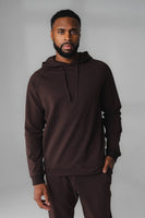 A man wearing Espresso Marl Studio Hoodie