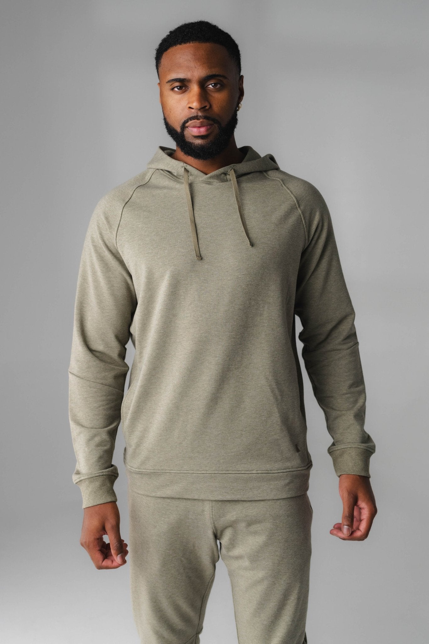 A man wearing Matcha Marl Studio Hoodie