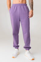 A man wearing the Vitality Uni Cozy Jogger in Violet