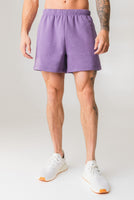 A man wearing the Vitality Uni Cozy Short in Violet