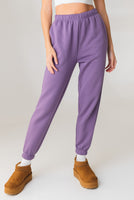 A woman wearing the Vitality Uni Cozy Jogger in Violet