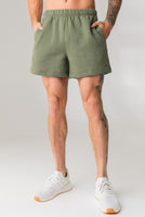 A man wearing the Vitality Uni Cozy Short in Willow
