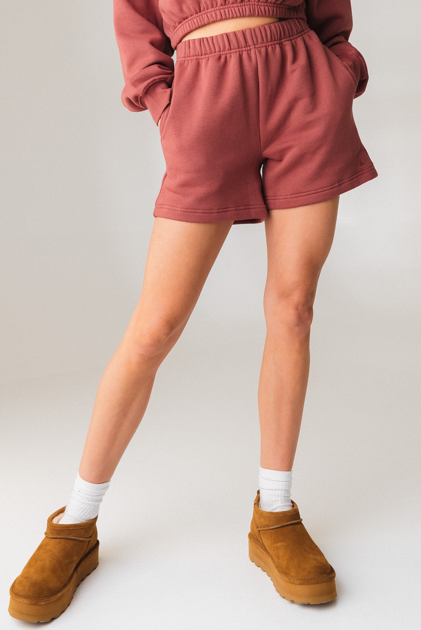 A woman wearing the Vitality Uni Cozy Short in Rosewood