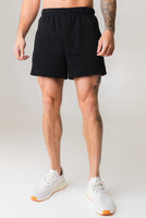 A man wearing the Vitality Uni Cozy Short in Midnight