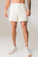 A man wearing the Vitality Uni Cozy Short in Oat