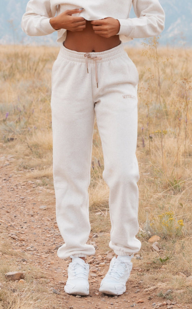 A woman wearing the Uni Cozy Jogger in Oat Marl