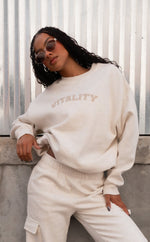 A woman wearing the Uni Cozy Crew in Oat Marl