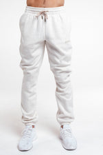 A man wearing the Uni Cozy Jogger in Oat Marl