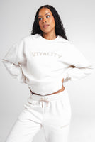 A woman wearing the Vitality Uni Cozy Crew in Oat Marl