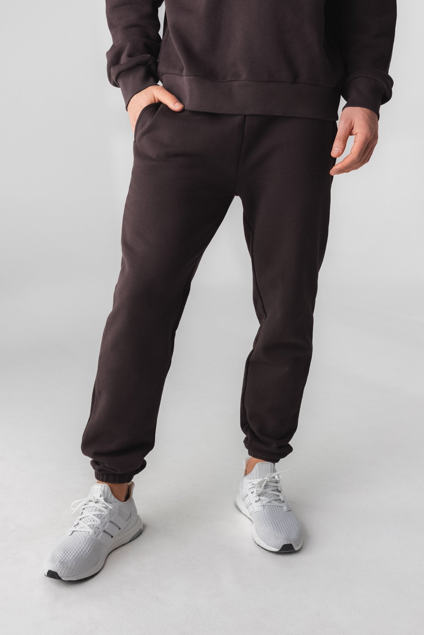 A man wearing Cozy Jogger - Obsidian, Gender Neutral Jogger from Vitality Athletic and Athleisure Wear
